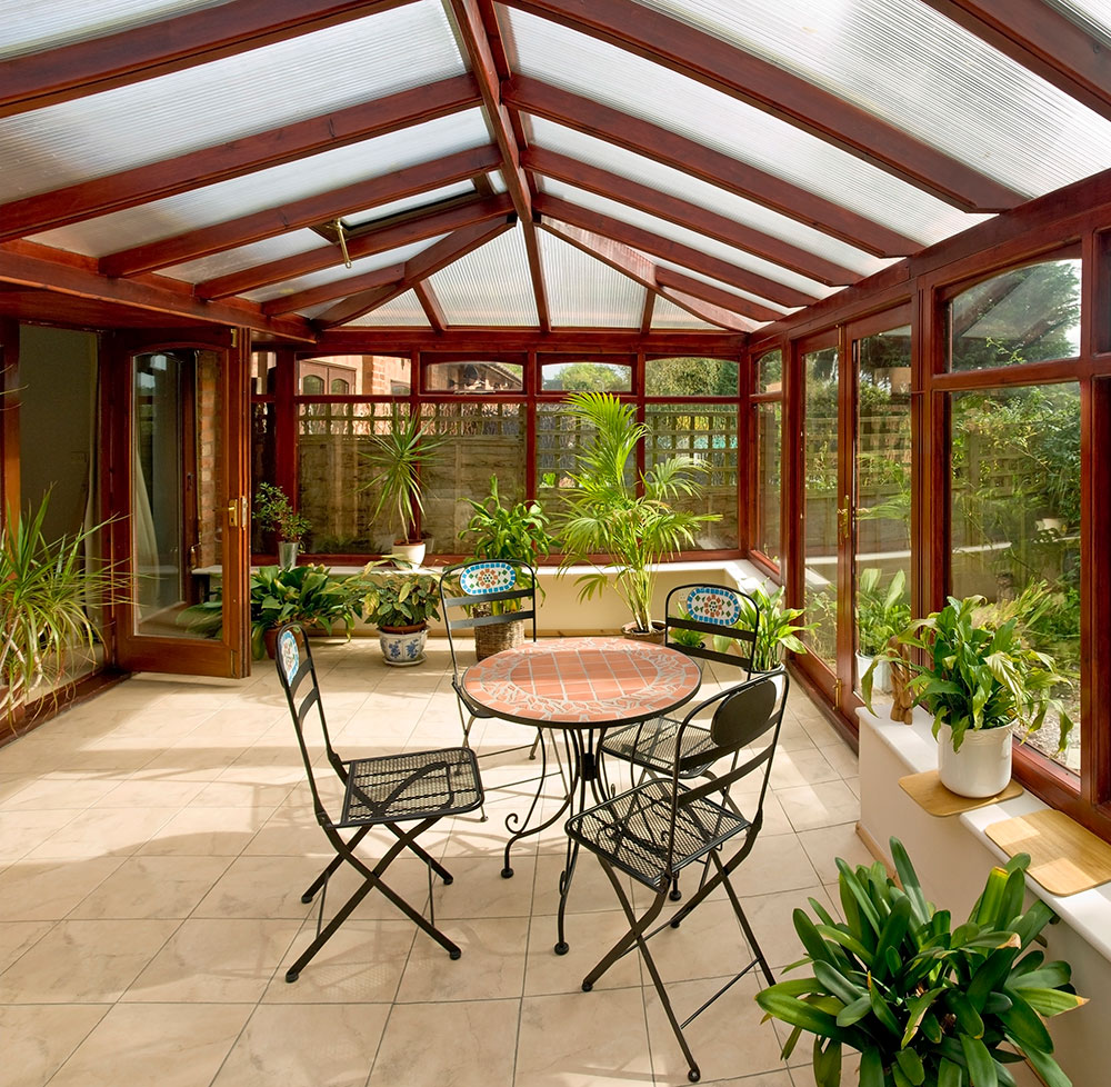 large conservatory with brown wood and glass