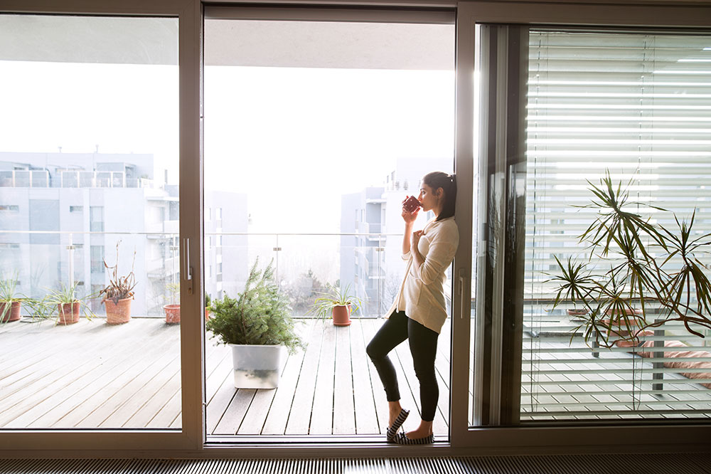 woman leaning on new glass sliding doors